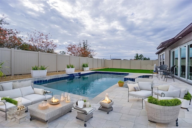 view of swimming pool with a patio area and an outdoor living space with a fire pit