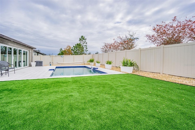 view of swimming pool featuring a patio area and a yard