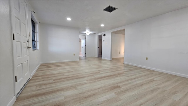 spare room featuring light hardwood / wood-style floors