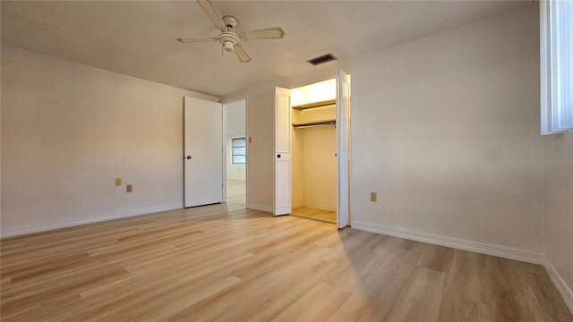 unfurnished bedroom featuring ceiling fan, a closet, and light hardwood / wood-style floors