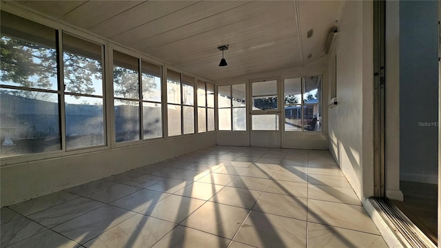 unfurnished sunroom featuring wood ceiling