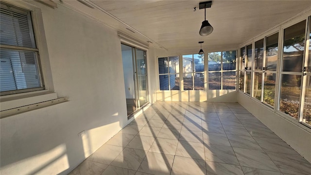 unfurnished sunroom featuring plenty of natural light and wood ceiling