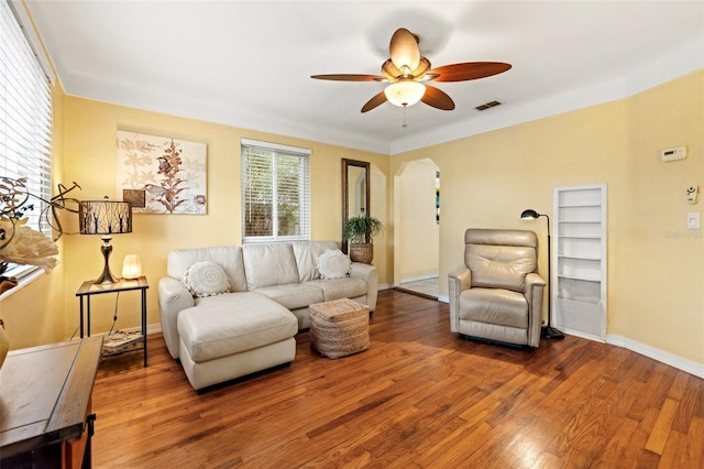 living room featuring ceiling fan and hardwood / wood-style flooring