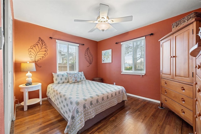 bedroom with ceiling fan and dark hardwood / wood-style floors