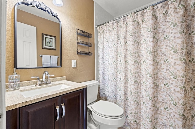 bathroom with toilet and vanity