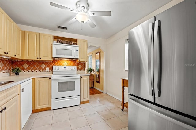 kitchen featuring white appliances, tasteful backsplash, light brown cabinetry, ceiling fan, and light tile patterned floors