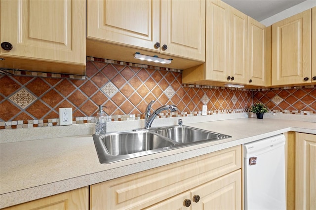 kitchen with light brown cabinetry, backsplash, sink, and white dishwasher