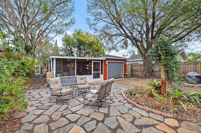 view of patio with a garage and a sunroom