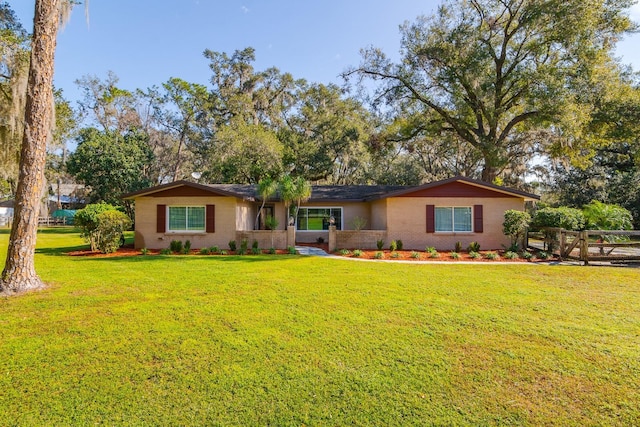 ranch-style house with a front lawn