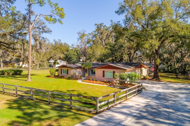 single story home with a front lawn