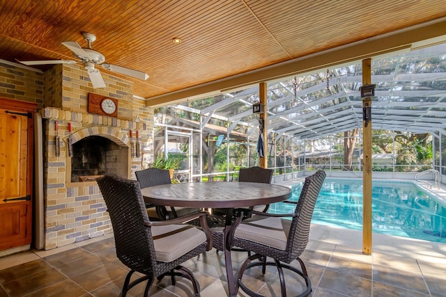 view of patio / terrace with glass enclosure, a fenced in pool, and an outdoor brick fireplace