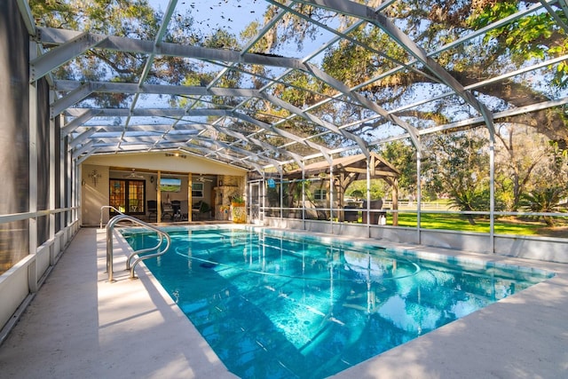 view of swimming pool featuring a lanai and a patio area