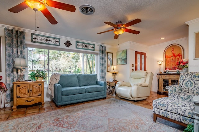 living room with ceiling fan, light tile patterned floors, crown molding, and a textured ceiling