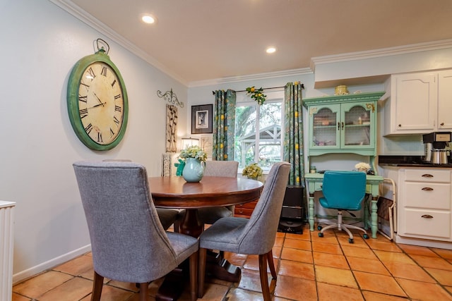 dining area with light tile patterned floors and ornamental molding