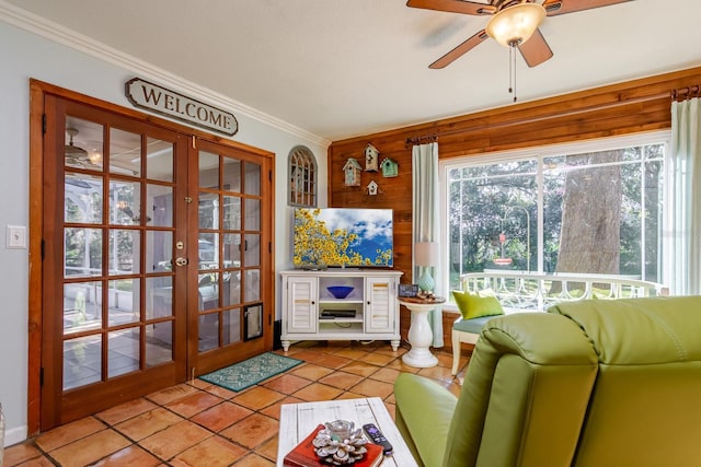 unfurnished sunroom featuring ceiling fan and french doors