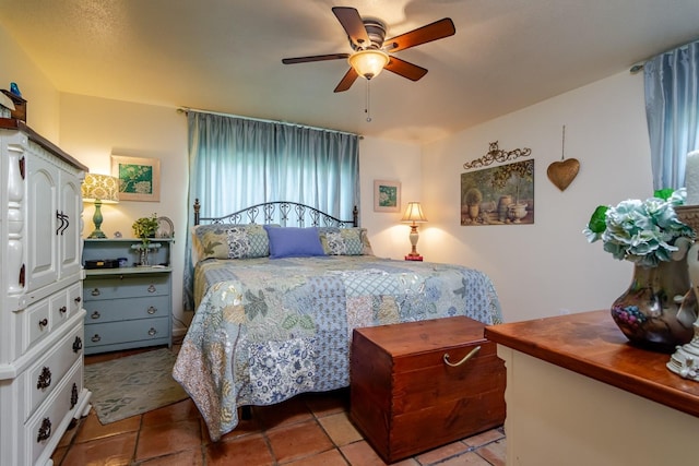 tiled bedroom with ceiling fan