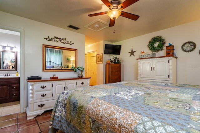 tiled bedroom with ceiling fan, ensuite bathroom, a closet, and sink