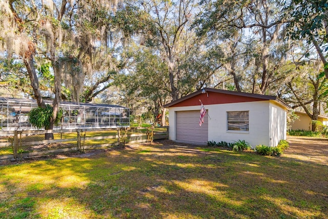 view of yard with a garage and an outdoor structure