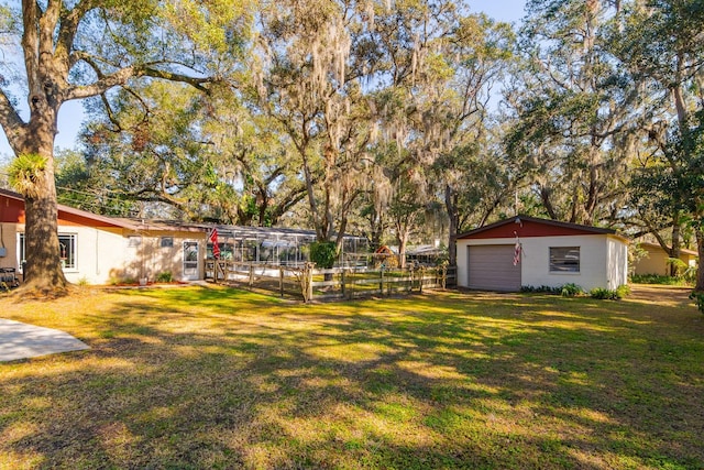 view of yard featuring a garage and an outdoor structure