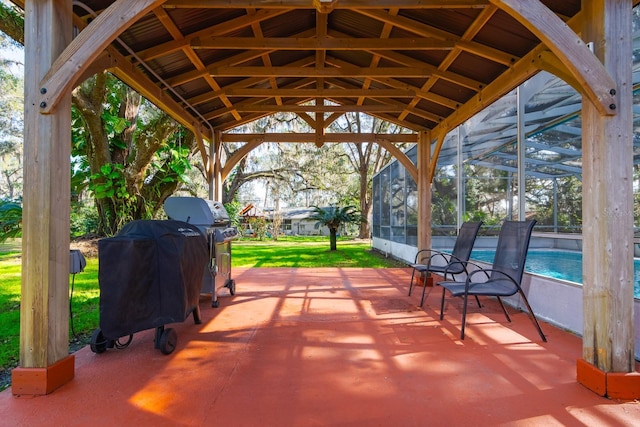 view of patio / terrace with a grill and glass enclosure