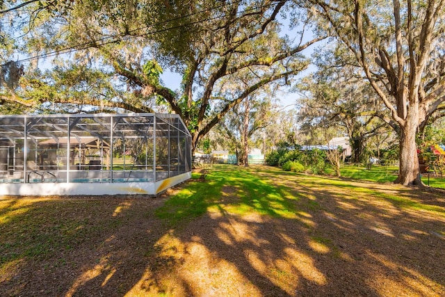 view of yard featuring glass enclosure