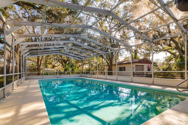 view of swimming pool with glass enclosure