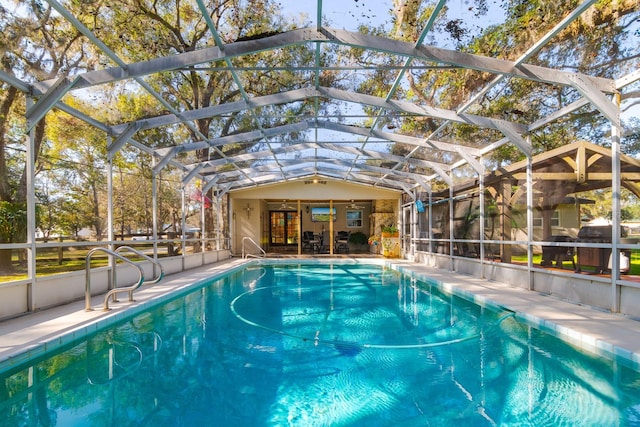 view of swimming pool with glass enclosure