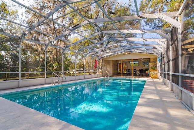 view of pool with a lanai and a patio area