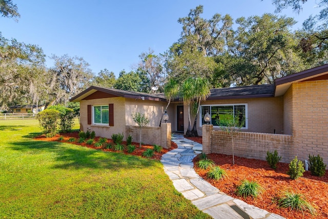 ranch-style house with a front lawn