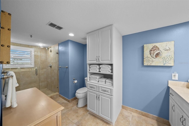 bathroom featuring vanity, an enclosed shower, and toilet