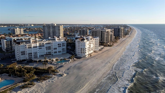 birds eye view of property with a water view and a beach view