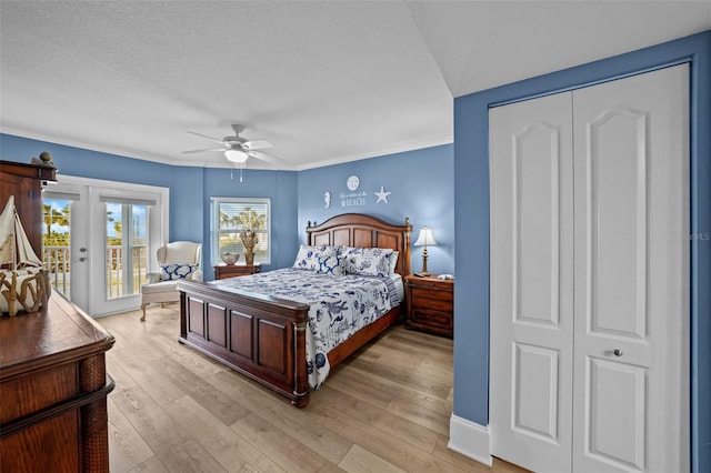 bedroom with access to outside, ceiling fan, light hardwood / wood-style floors, a textured ceiling, and french doors