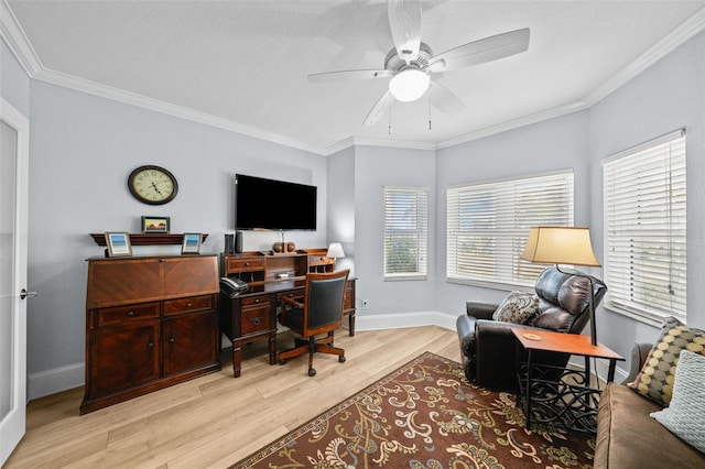 home office with crown molding, ceiling fan, and light wood-type flooring