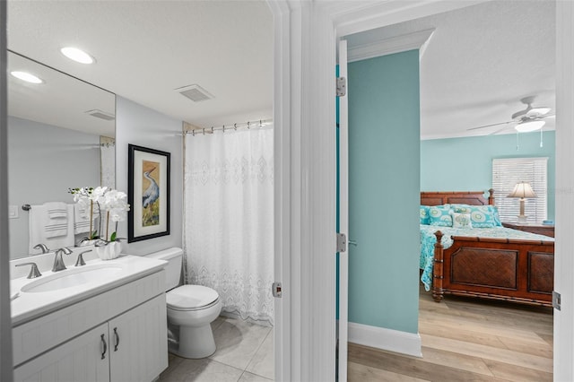 bathroom featuring vanity, wood-type flooring, ceiling fan, and toilet