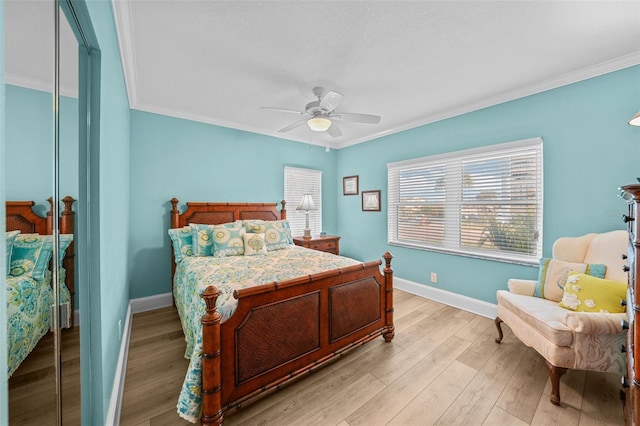 bedroom with ornamental molding, light hardwood / wood-style floors, and ceiling fan