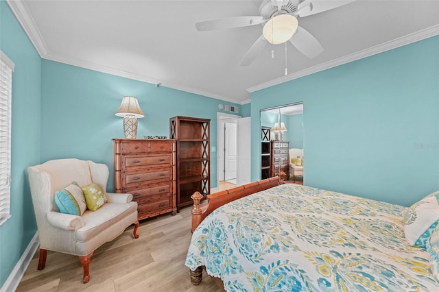 bedroom featuring ornamental molding, a closet, ceiling fan, and light wood-type flooring