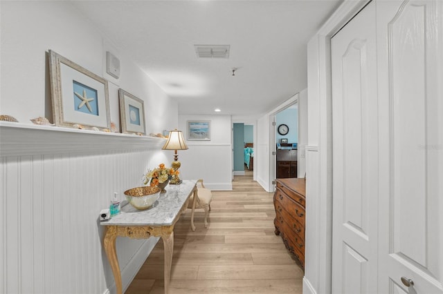 corridor with light hardwood / wood-style floors