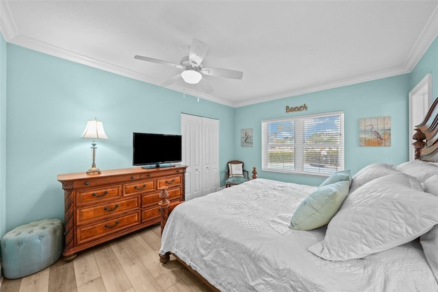 bedroom with light hardwood / wood-style flooring, ornamental molding, and a closet