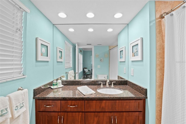 bathroom with vanity, toilet, and a shower with shower curtain