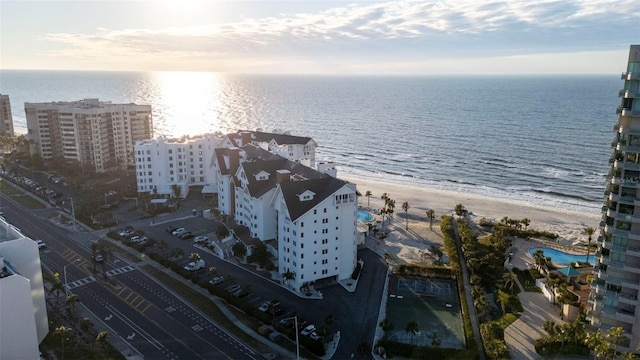 aerial view with a water view and a beach view