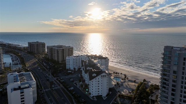 aerial view at dusk featuring a water view