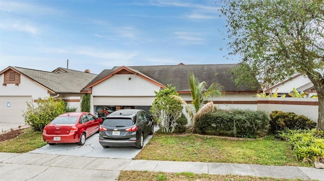 ranch-style home featuring a garage and a front yard