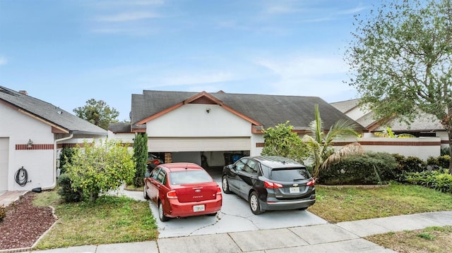 view of front of property with a garage and a front lawn