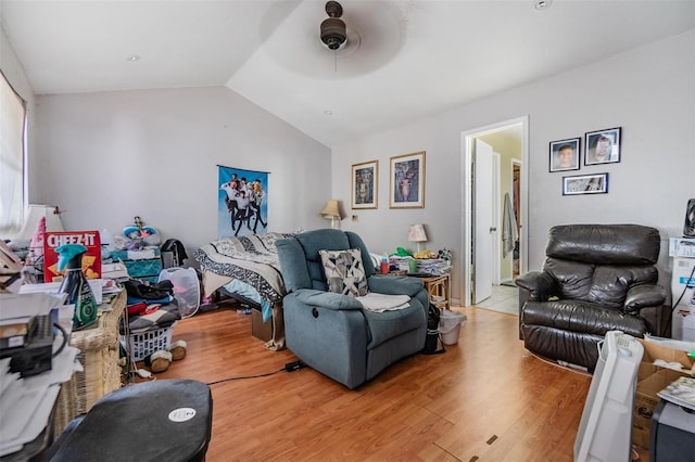 living room with lofted ceiling, ceiling fan, and light hardwood / wood-style floors