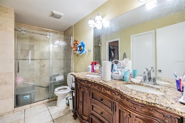 bathroom featuring tile patterned floors, toilet, vanity, and walk in shower