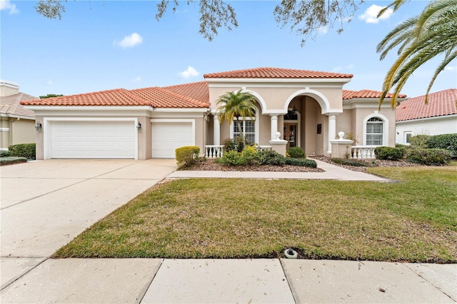 mediterranean / spanish-style house with a garage and a front lawn