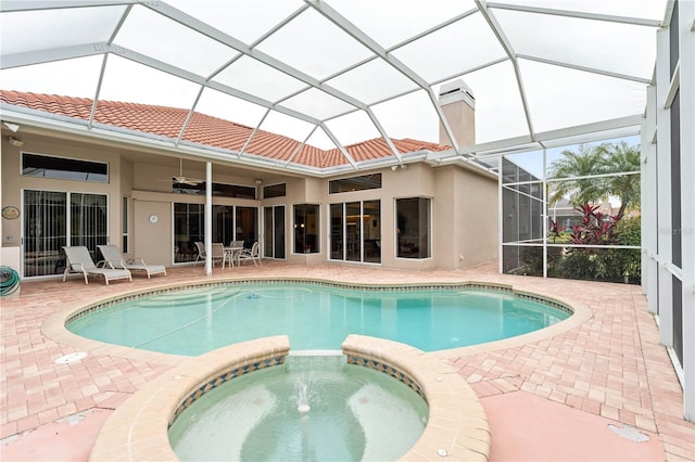 view of pool featuring a lanai, a patio, and an in ground hot tub