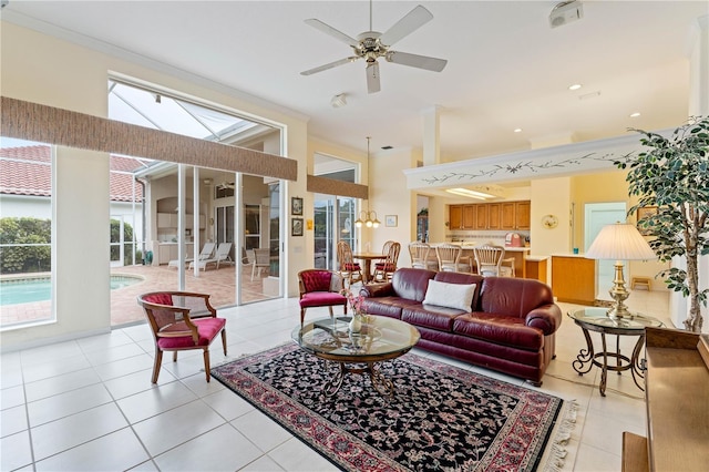 tiled living room with crown molding and ceiling fan