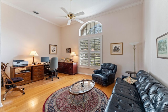 home office with crown molding, ceiling fan, a healthy amount of sunlight, and light hardwood / wood-style floors