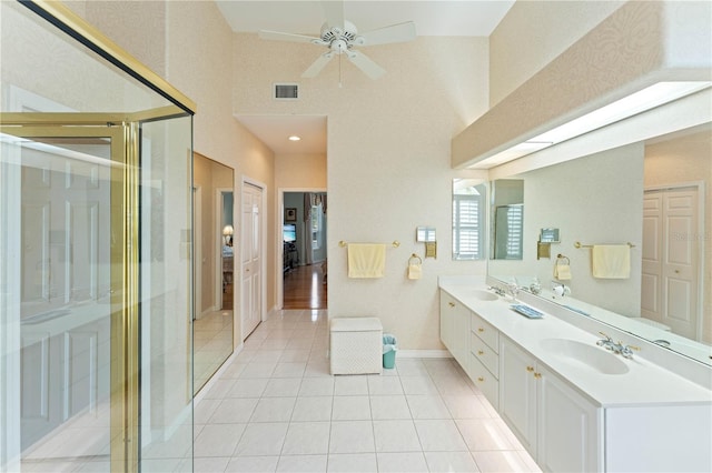 bathroom with tile patterned flooring, vanity, ceiling fan, and a shower with shower door